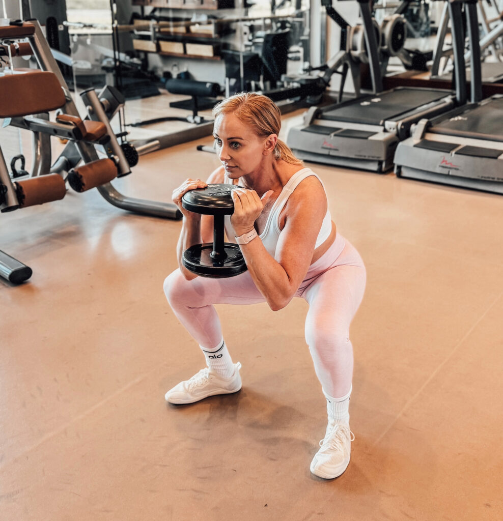 Woman Over 40 weight training-performing a Dumbbell Goblet Squat